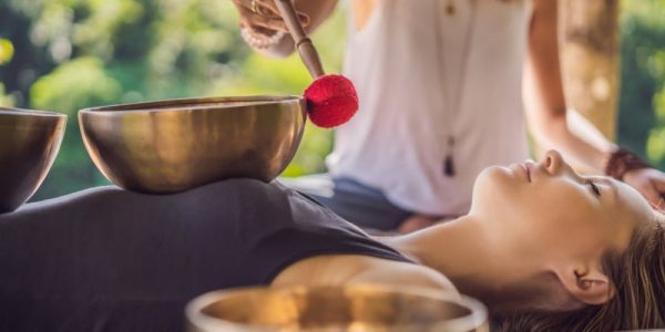 Sound massage with bowls played on the dressed body
